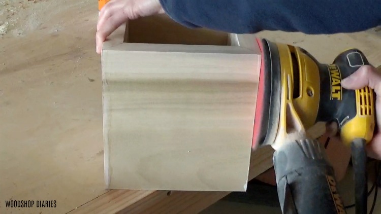 Sanding the edges and sides of the urn