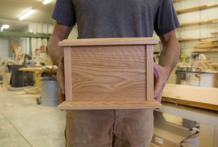 Hand-finishing a wooden urn in our workshop
